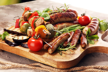 Obraz na płótnie Canvas Assorted delicious grilled meat with vegetable on a barbecue. Grilled pork shish or kebab on skewers with vegetables . Food background shashlik