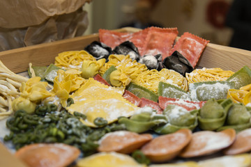 Display of a Food Store with Various Rows of Raw Coloured Pasta