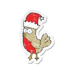 retro distressed sticker of a cartoon robin in christmas hat
