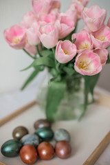 A bouquet of spring beautiful flowers in a glass vase. Fresh Pink tulips on white background.