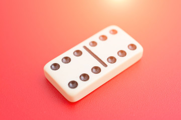 Dominoes on red table