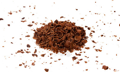 Grated chocolate. Pile of ground chocolate isolated on white background, closeup