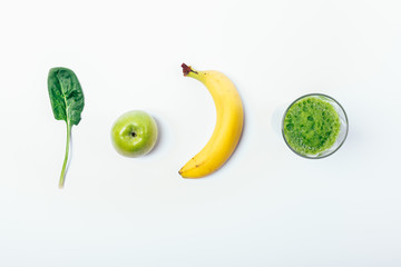 Top view of whole ingredients and ready-made green smoothie