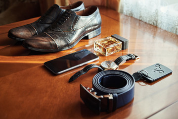 different accessories of a businessman for creating a style of a people lie on a wooden background