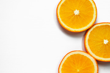 Orange slices on white background. Tropical bright juicy fruit vegetarian healthy diet flat lay banner