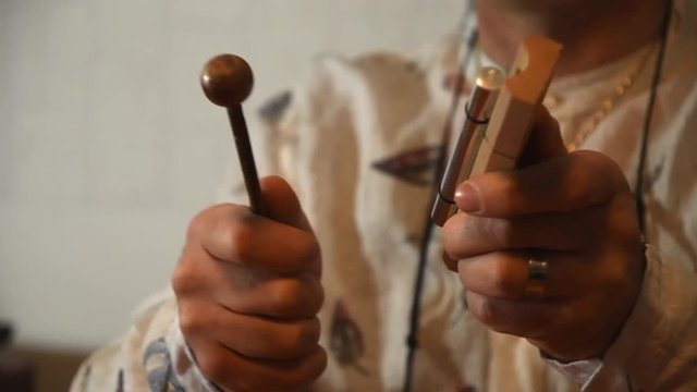 close up of a man's hands using a energy bar chime