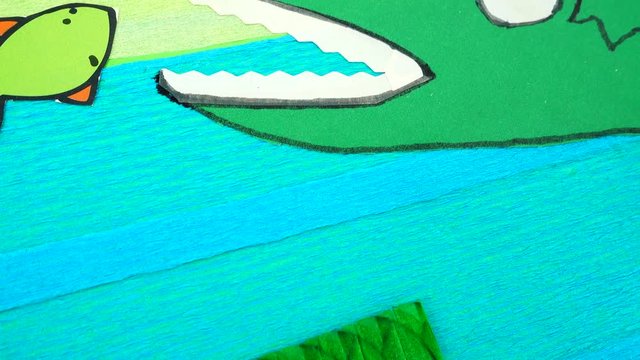 Applique of a crocodile in a pond.