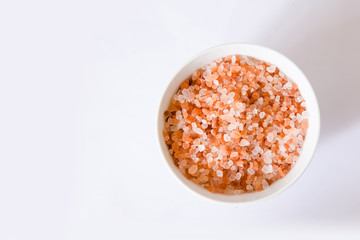 Himalayan mountain pink rock salt on a white background in a round bowl