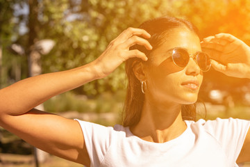Portrait of a young woman in sunglasses on a sunny day