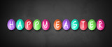 colored eggs with letters forming the word easter on blackboard background