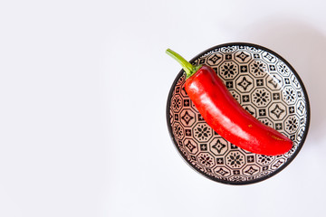 medium hot serenade chillies whole  red in a round bowl with white background