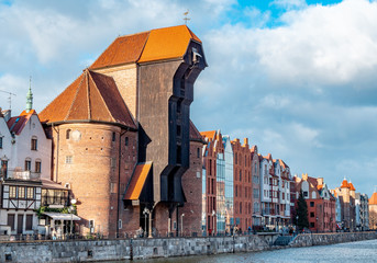 Old city in Poland with the oldest medieval port crane (Zuraw) in Europe and a promenade along the riverbank of Motlawa River - obrazy, fototapety, plakaty