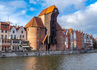 Old city in Poland with the oldest medieval port crane (Zuraw) in Europe and a promenade along the riverbank of Motlawa River - obrazy, fototapety, plakaty