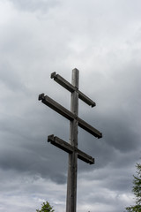 Alpe di Siusi, Seiser Alm with Sassolungo Langkofel Dolomite, a wooden pole in a cloudy sky