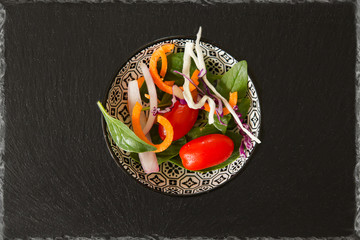 Exotic tomatoes rosa side salad cabbage carrots onions on a black background
