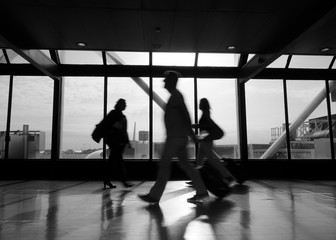 Airport rush several people rushing through an airport terminal