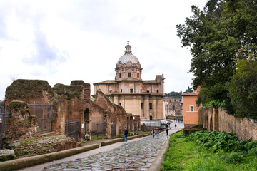 path among the ancient ruins in Rome on a rainy day in spring, old Catholic temple