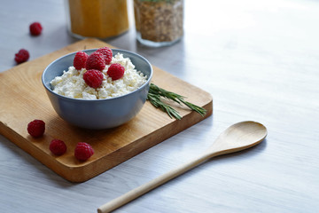 Diet, healthy breakfast. Cottage cheese with fresh raspberries in a bowl