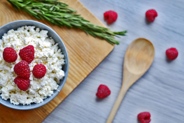 Diet, healthy breakfast. Cottage cheese with fresh raspberries in a bowl