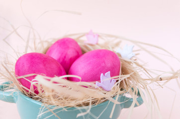 3 pink eggs in a nest on a beige background, Easter , a dove, a plate - Powered by Adobe