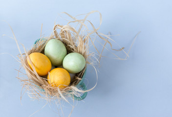 2, yellow, green, eggs, Easter, nest, blue background,