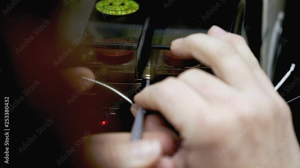 Poster a worker operating a wire terminating machine at a stock-wire factory. front close-up shot, detail o