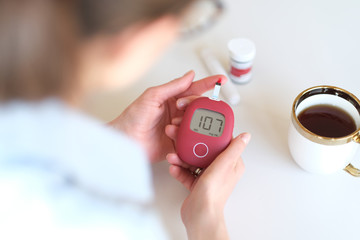 Woman sick on diabetes, is checking her glucose level.