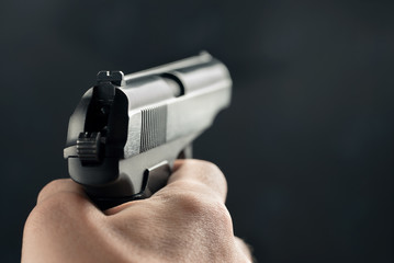 Gun in the man's hand. Point of view