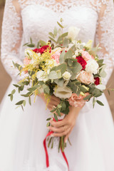 White wedding bouquet in the hands of the bride