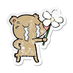 distressed sticker of a cartoon crying bear with flower