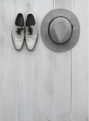 white men's shoes and white hat