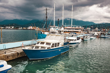 Fototapeta na wymiar Boats near the port under sky