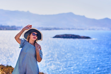 Beautiful woman in beach hat enjoying sea view with blue sky at sunny day in Bodrum, Turkey. Vacation Outdoors Seascape Summer Travel Concept