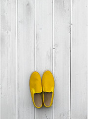 yellow summer shoes on white wooden floor