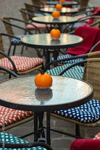 Glass Tables Of An Outdoor Cafe With Pumpkins And Colored