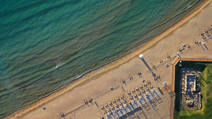Aerial drone photo of iconic turquoise sandy celebrity beach of Asteras or Astir and ancient temple...