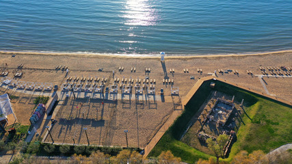 Aerial drone photo of iconic turquoise sandy celebrity beach of Asteras or Astir and ancient temple...