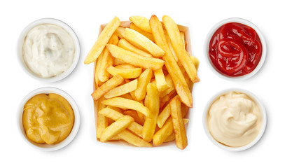 French fries with ketchup, mayonnaise, mustard, garlic sauce top view isolated on white background