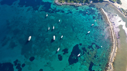 Aerial drone photo of famous small islet with picturesque chapel of Agios Nikolaos and small marina, Anavissos area, Attica, Greece