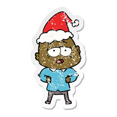 distressed sticker cartoon of a tired bald man wearing santa hat