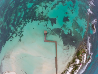 Aerial view on Crystal clear turquoise water of Caribbean Sea and Coast of Isla Mujeres in Mexico 