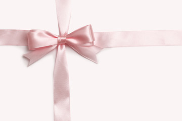 Pink bow and ribbon on a white background