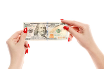 Perfect womens hands hold one hundred dollars isolated on white background. Perfect red manicure.