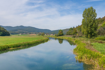 Fototapeta na wymiar landscape view of riverbanks of gacka in central croatia