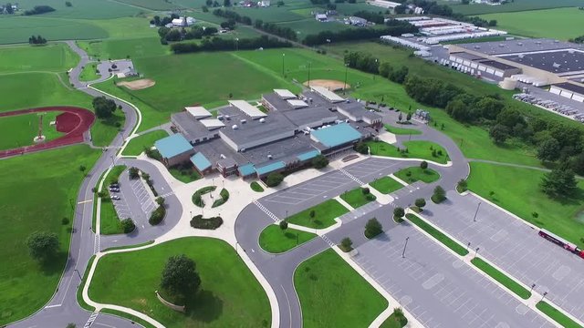 Aerial view of a High School with its parking and green zones in a residential neighborhood of Pennsylvania.