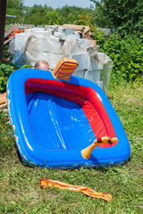Someone inflates children's rubber pool on a hot summer day