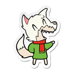 sticker of a laughing fox wearing winter clothes