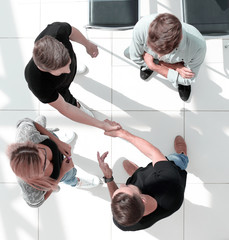 High angle view of a team of united businesspeople standing