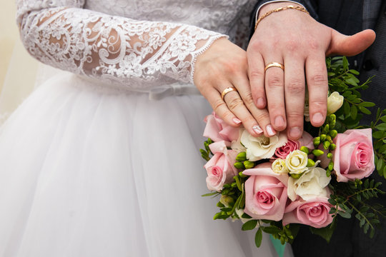 rings on the hands of the newlyweds
