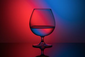 Fototapeta na wymiar futuristic image of a glass on a red-blue background